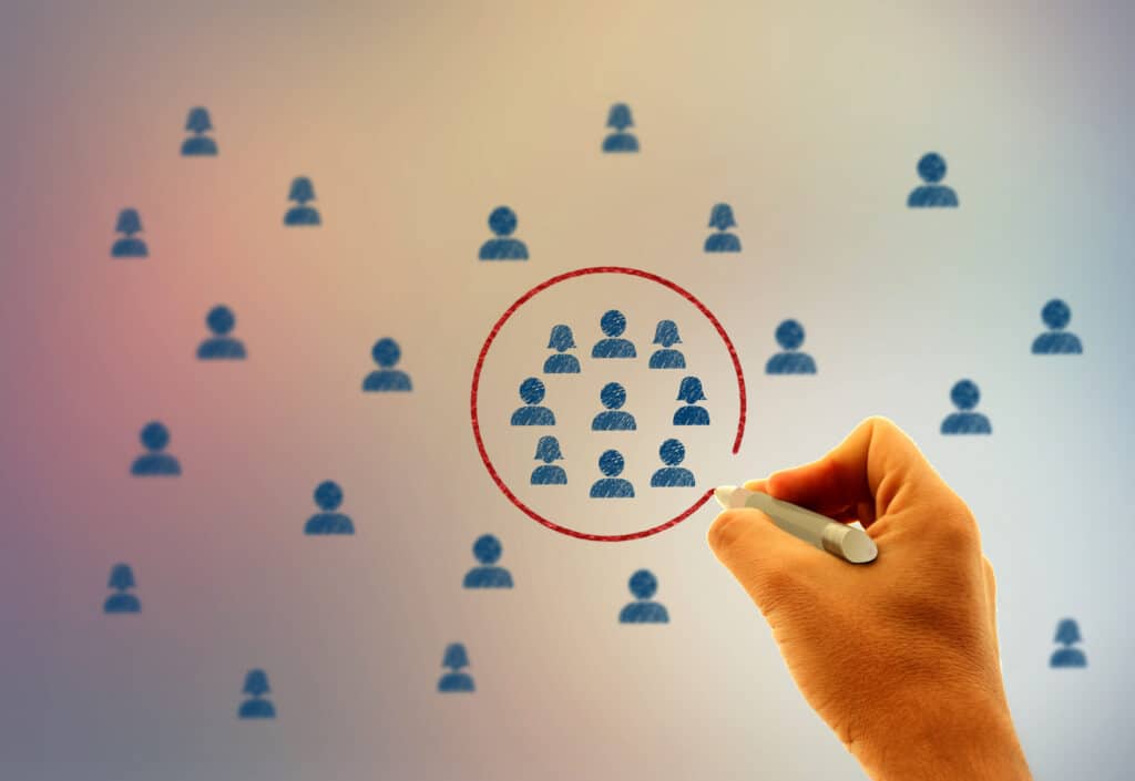 Depiction of stylized people, with a hand holding a marker draws a circle around a subset of them.